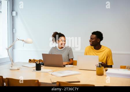 Happy young students studying together at university Stock Photo