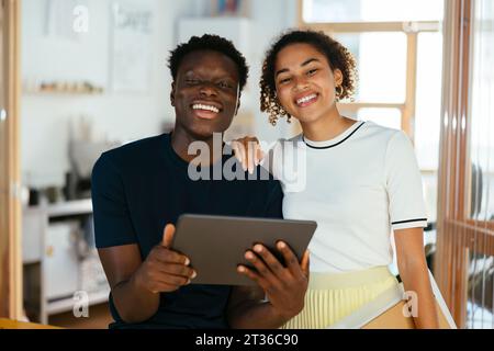Happy students with tablet PC together at university Stock Photo