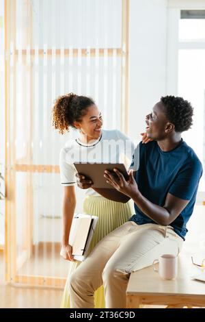 Happy young students using tablet PC at university Stock Photo