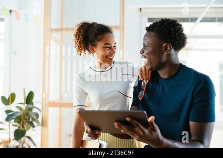 Happy students with tablet PC at university Stock Photo