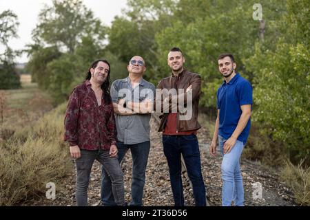 Smiling friends standing amidst plants Stock Photo