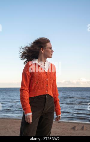 Young woman standing at beach Stock Photo