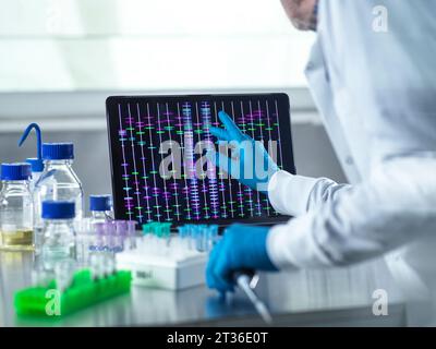 Scientist using laptop for genetic research in laboratory Stock Photo