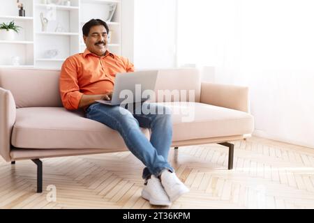 Middle aged Indian Man Exploring the Digital World Stock Photo