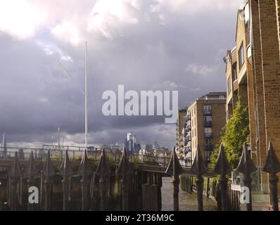 London, UK - Oct 21 2023: a Thames view of the City of London from behind the terrace railings of The Grapes pub in Limehouse Stock Photo