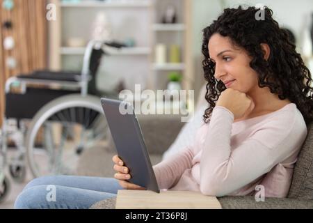 disabled young businesswoman using digital tablet Stock Photo