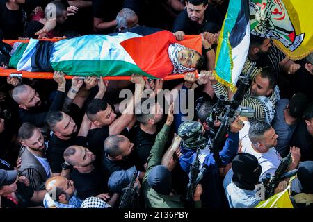 (EDITORS NOTE: Image depicts death)Mourners carry the body of one of two Palestinian men who were killed during an Israeli raid on the village of Zawata, west of the city of Nablus in the Israeli occupied West Bank amid the ongoing battles between Israel and the Palestinian Islamist group Hamas in the Gaza Strip. Thousands of people, both Israeli and Palestinian have died since October 7, 2023, after Palestinian Hamas militants based in the Gaza Strip, entered southern Israel in a surprise attack leading Israel to declare war on Hamas in Gaza on October 8. (Photo by Nasser Ishtayeh/SOPA Imag Stock Photo