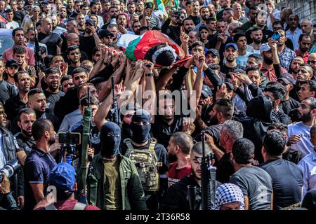 (EDITORS NOTE: Image depicts death)Mourners carry the body of one of two Palestinian men who were killed during an Israeli raid on the village of Zawata, west of the city of Nablus in the Israeli occupied West Bank amid the ongoing battles between Israel and the Palestinian Islamist group Hamas in the Gaza Strip. Thousands of people, both Israeli and Palestinian have died since October 7, 2023, after Palestinian Hamas militants based in the Gaza Strip, entered southern Israel in a surprise attack leading Israel to declare war on Hamas in Gaza on October 8. Stock Photo