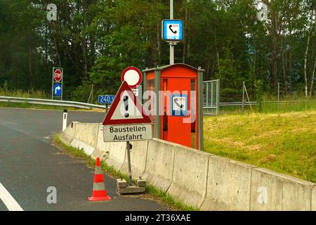 Emergency SOS phone booth on the highway. Roadside emergency call system. Stock Photo