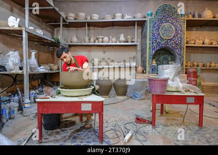 Rishton, Uzbekistan - October 22, 2023: A man working in his pottery workshop in Rishton, Uzbekistan. Stock Photo