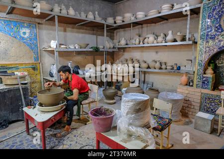 Rishton, Uzbekistan - October 22, 2023: A man working in his pottery workshop in Rishton, Uzbekistan. Stock Photo