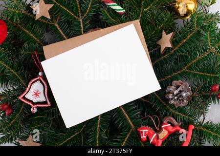Christmas 5x7 card mockup template with envelop on natural fir branch background Stock Photo