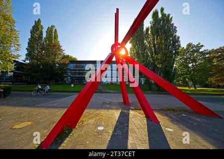 Bright red sculpture made of steel profiles L'Allume by Mark di Suvero in front of the Bundeshaus on the Rhine, Bonn, North Rhine-Westphalia, Germany Stock Photo