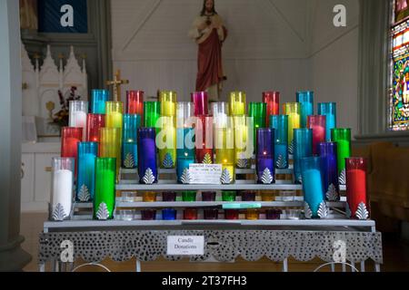 Votive candles in St Augustines Roman Catholic church, South Rustico, Prince Edward Island, Canada Stock Photo