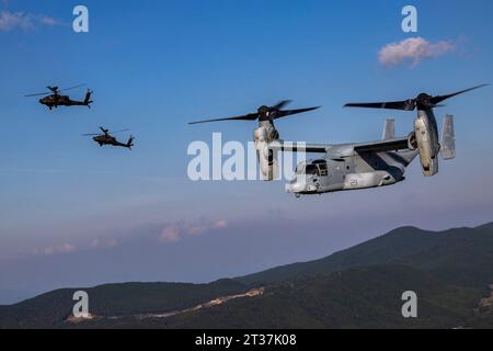 Kumamoto, Japan. 18th Oct, 2023. A U.S. Marines MV-22 Osprey tilt-rotor aircraft assigned to Medium Tiltrotor Squadron 262 conducts a bilateral formation flight alongside Japan Ground Self-Defense Force AH-64 Apache attack helicopters during Resolute Dragon 23 at Japan Ground Self-Defense Force Jumonjibaru Proving Grounds, October 19, 2023 in Kumamoto, Kyushu, Japan. Credit: Cpl. Kyle Chan/U.S. Marine Corps/Alamy Live News Stock Photo
