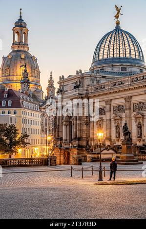 Illuminated art gallery in the Lipsius Building on Georg-Treu-Platz with the Frauenkirche Dresden at dawn, Saxony, Germany Stock Photo
