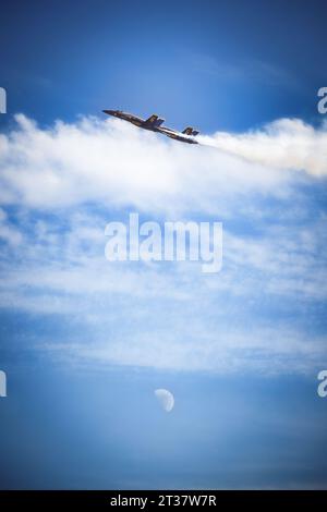 Miramar, California, USA - September 23, 2023: Two Blue Angels soar above the moon at America's Airshow 2023. Stock Photo