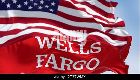 San Francisco, US, Oct. 1 2023: Close-up of Wells Fargo bank flag waving with blurred american flag in the foreground. Illustrative editorial 3d illus Stock Photo