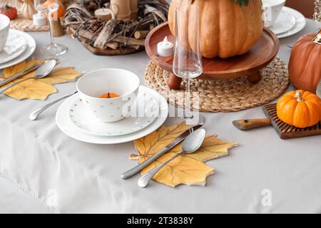 Festive table setting with autumn leaves and pumpkins, closeup Stock Photo