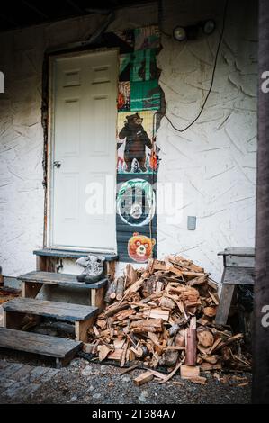Piles of cut and split firewood, ready for winter, piled behind a mountain house.  Whistler BC, Canada. Stock Photo