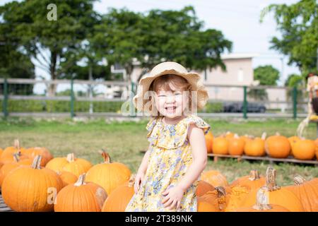 Smiling preschool kid at the farm. Pumpkin patch american tradition. Halloween fun Stock Photo