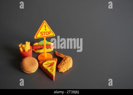 Closeup image of STOP signboard and junk foods. Stop eating unhealthy food concept. Stock Photo