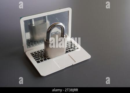Closeup image of laptop and padlock with copy space. Cyber security concept. Stock Photo