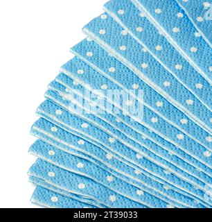 Stack of blue dotted paper napkins isolated on white Stock Photo