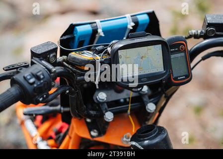 REPUBLIC OF KARELIA, RUSSIA - CIRCA JUNE, 2022: Off-road tournament Ladoga Trophy 2022 in Karelia. Navigator is mounted on steering wheel of sports motorcycle for orientation on map during race Stock Photo