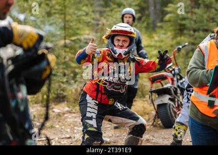 REPUBLIC OF KARELIA, RUSSIA - CIRCA JUNE, 2022: Off-road tournament Ladoga Trophy 2022 in Karelia. Portrait of a motorcycle racer in a helmet before the start of the race Stock Photo