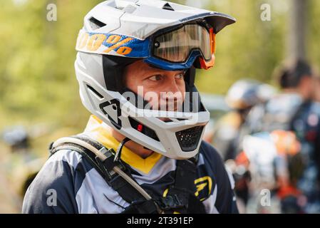 REPUBLIC OF KARELIA, RUSSIA - CIRCA JUNE, 2022: Off-road tournament Ladoga Trophy 2022 in Karelia. Portrait of a motorcycle racer in a helmet before the start of the race Stock Photo