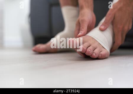 man using put on elastic bandage with legs having leg pain Stock Photo