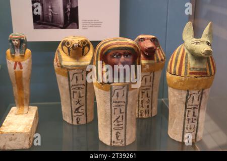 Four painted wooden dummy Canopic jars and a painted wooden statuette of Imsety, one of the sons of Horus at the British Museum, London, UK Stock Photo