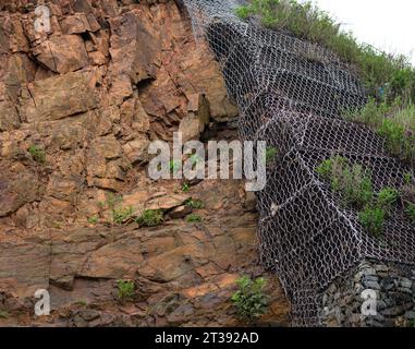 Metal fastenings to strengthen slopes - prevent landslides and destruction. Stock Photo