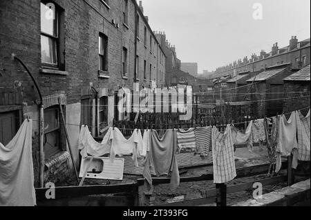 Washing hanging in the backyards of a street of terraced houses awaiting demolition during the slum clearance of St Ann's, Nottingham. 1969-1972 Stock Photo