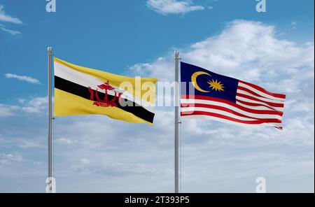 Malaysia and Brunei flags waving together in the wind on blue cloudy sky, two country relationship concept Stock Photo