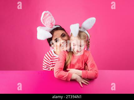 Family easter. Sister girls with bunny ears. Egg hunt. Happy childhood. Isolated. Stock Photo