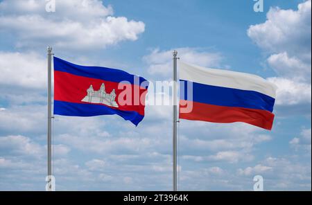 Russian Federation and Cambodia flags waving together in the wind on blue cloudy sky Stock Photo