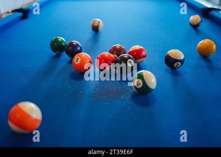 Closeup of colorful billiard balls on blue pool table in daylight Stock Photo