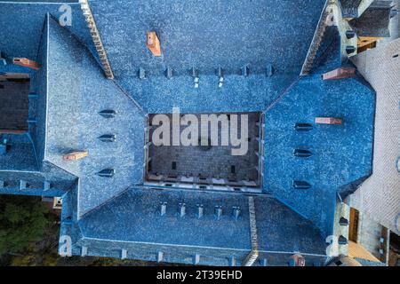 Aerial top view of medieval castle Alcazar of Segovia Spain with blue open ceiling red chimneys slope walls air circulation ventilation in daylight Stock Photo