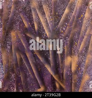 A mesmerizing painting texture of deep purple rays intertwined with golden speckles and intricate patterns. Stock Photo