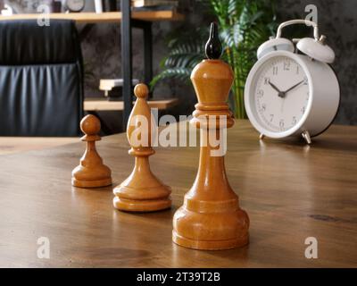 Chess pieces stand on the table as a symbol of career, professional growth and corporate hierarchy. Stock Photo