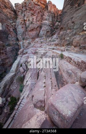 Stairs in the rock along Al Kubtha Trail (Indiana Jones Trail) leading to Al-Khazneh Treasury in the historic and archaeological city of Petra, Jordan Stock Photo