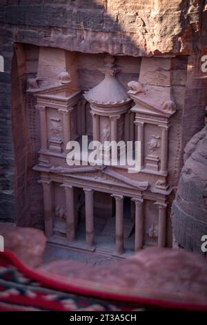 High angle view of famous Al-Khazneh Treasury in the historic and archaeological city of Petra in Jordan from Al-Kubtha Trail (Indiana Jones Trail) Stock Photo