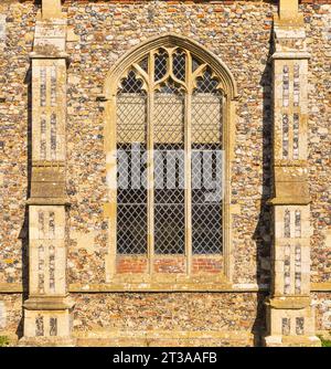 Church wall and arched leaded window exterior on a Suffolk church. UK Stock Photo