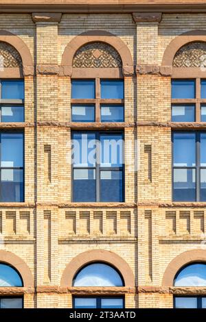 Park Slope, Brooklyn: Acme Hall, a Romanesque Revival building with elaborate brickwork, tall transom-topped windows, and corner tower. Stock Photo