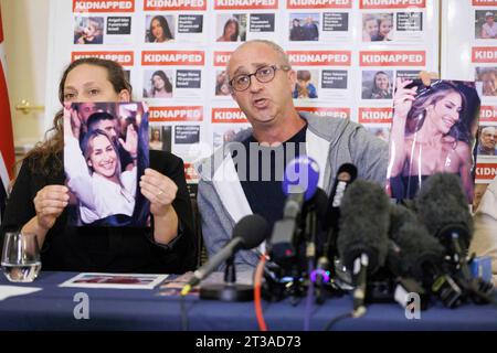 British-Israeli Ayelet Svatitzky whose mother and brother were taken hostage from Kibbutz Nirim (left) and British-Israeli David Barr whose sister-in-law Naomi was murdered on her morning run speaking during a press conference for the families of British-Israeli kidnap victims of the Israel-Hamas conflict, at the Israeli Embassy in London. Stock Photo
