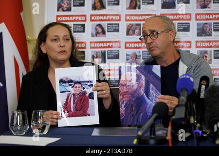 British-Israeli Ayelet Svatitzky whose mother and brother were taken hostage from Kibbutz Nirim (left) and British-Israeli David Barr whose sister-in-law Naomi was murdered on her morning run speaking during a press conference for the families of British-Israeli kidnap victims of the Israel-Hamas conflict, at the Israeli Embassy in London. Stock Photo