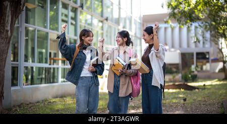 University student friendship concept with classmate friend walk together at campus college park. Youth teenage and education Stock Photo