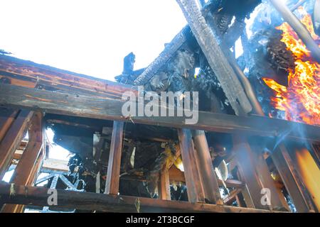 Burning house fully engulfed structure completely destroyed by fire. Stock Photo